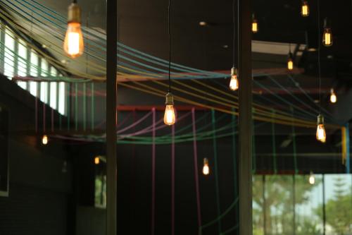a group of lights hanging from the ceiling of a building at Navela Hotel & Convention in Ratchaburi