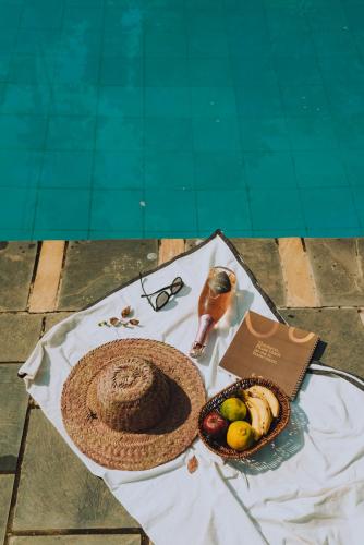 a table with a hat and a bowl of fruit at Machan Country Villa in Chitwan