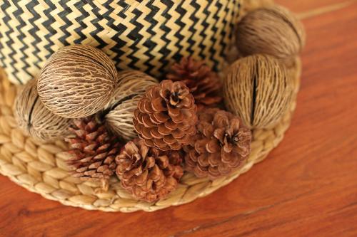 a basket filled with pine cones and pine needles at Navela Hotel & Convention in Ratchaburi