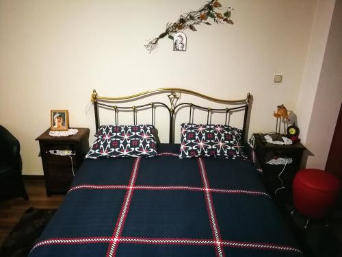 a bedroom with a blue bed with two pillows at The dreamhouse kastoria in Dhendrokhórion