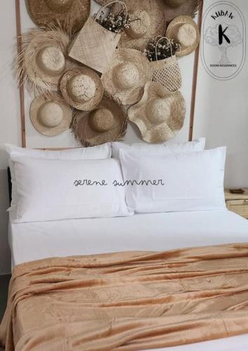 a bed with a bunch of hats on the wall at Serene Summer close proximity to Araneta Centre in Manila
