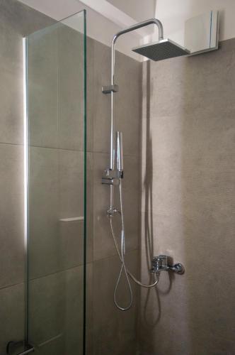 a shower in a bathroom with a glass door at AK Luxury Lofts in Ioannina