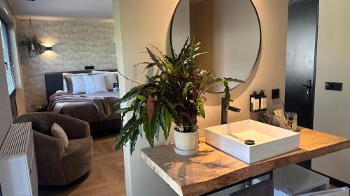 a bathroom with a sink and a mirror and a bed at Boutique Hotel Le Faucon in Valkenburg