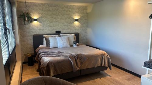a bedroom with a bed with two pillows on it at Boutique Hotel Le Faucon in Valkenburg