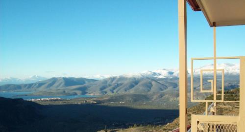 a view of a mountain range with snow covered mountains at Nidimos Hotel in Delfoi