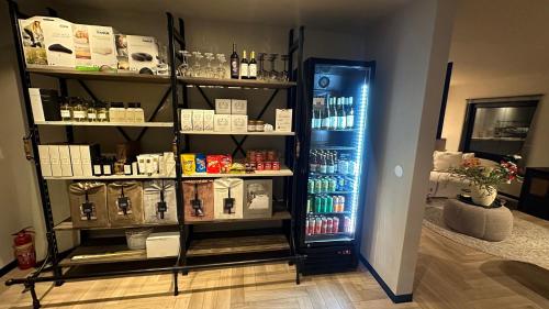 a room with a refrigerator and a shelf with products at Boutique Hotel Le Faucon in Valkenburg