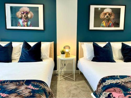two beds in a room with blue walls at Ground Floor - Near the Beach - 3 Bedroom - New - in Bournemouth