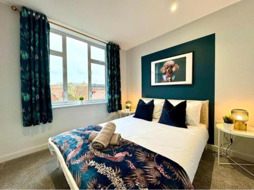 a bedroom with a large bed and a window at Ground Floor - Near the Beach - 3 Bedroom - New - in Bournemouth