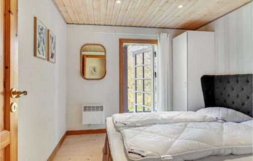 a bedroom with a bed and a window at Amazing Home In Græsted With Jacuzzi in Græsted