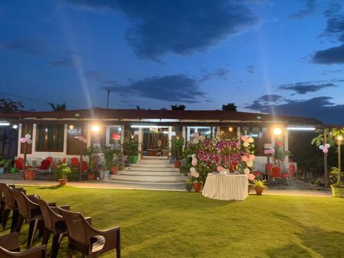 a wedding reception in front of a house at night at Love Green Resorts in Palladam