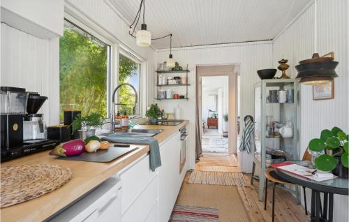 a kitchen with white counters and a large window at Cozy Home In Kalundborg With Wifi in Kalundborg