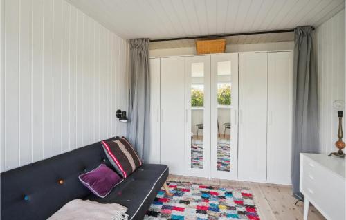 a living room with a black couch and a window at Cozy Home In Kalundborg With Wifi in Kalundborg