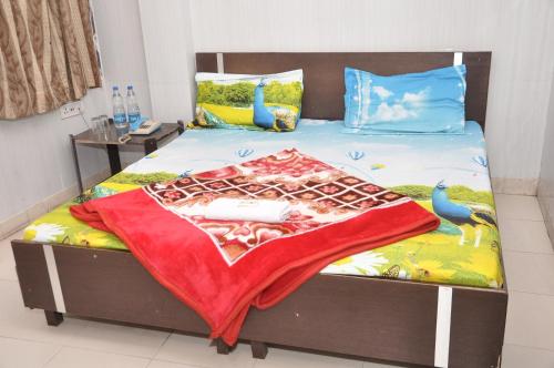 a bed with a blanket on top of it at Asha Guest House in Amritsar