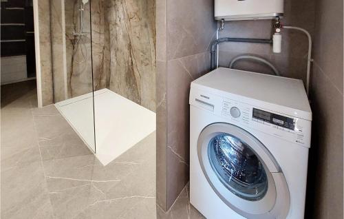 a washing machine in a bathroom next to a shower at Lovely Home In Cuers With Kitchen in Cuers