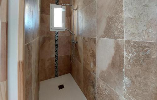 a shower in a bathroom with a window on the wall at Lovely Home In Cuers With Kitchen in Cuers