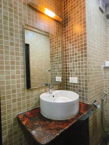 a bathroom with a sink and a mirror at Sia Signature Calangute in Calangute