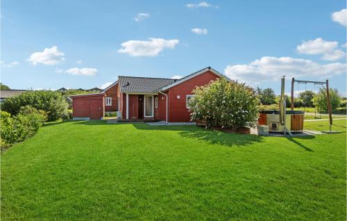 a red house with a green lawn at Amazing Home In Frørup With Wifi in Frørup