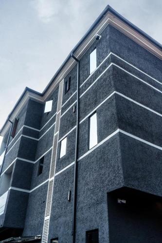 a tall brick building with windows on the side of it at Carizma Luxury Apartments, Ikeja in Lagos