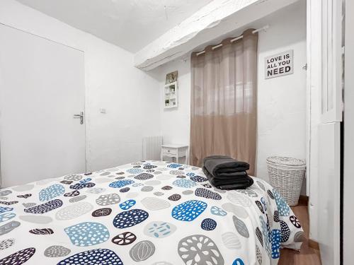 a bedroom with a bed with a comforter on it at Loft cosy au cœur de Vence in Vence