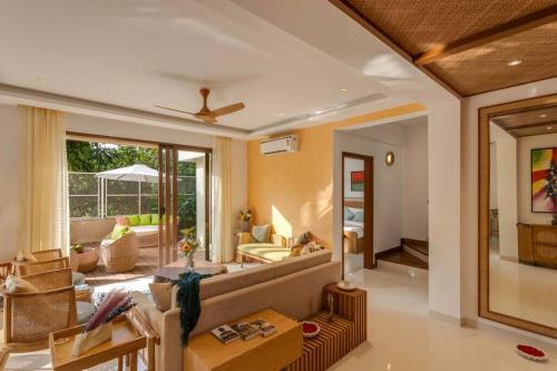 a living room with a couch and a table at Villa Cosmos - 3bed with a private pool in Anjuna By Masaya Stays in Bardez