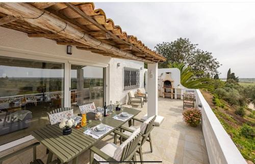 a patio with a table and chairs on a house at Luxury 2 Bedroom Villa on Quinta da Saudade in Pêra