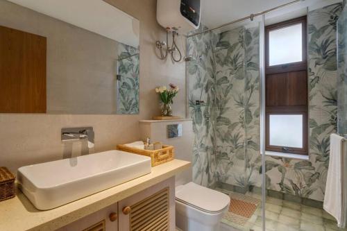 a bathroom with a sink and a toilet and a shower at Villa Cosmos - 3bed with a private pool in Anjuna By Masaya Stays in Bardez