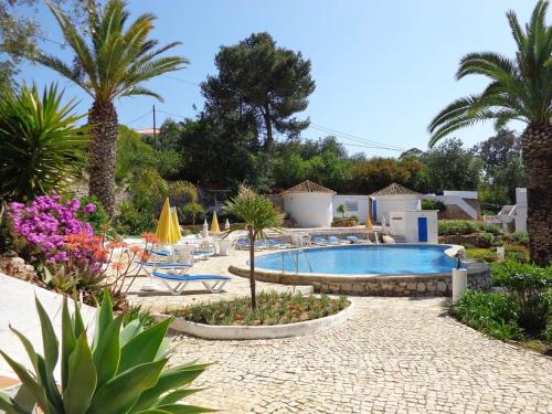 a resort with a swimming pool and palm trees at Luxury 2 Bedroom Villa on Quinta da Saudade in Pêra