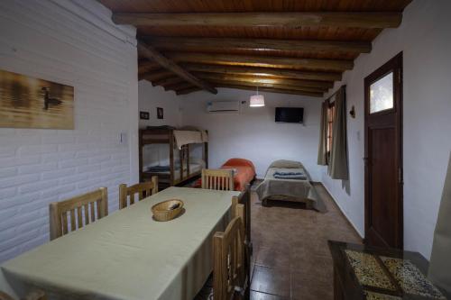 a room with a kitchen with a table and a couch at Cabañas San José de Pemehué in San Rafael