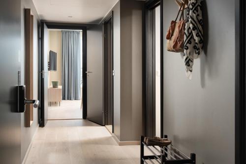 a hallway with a door leading into a room at BJØRVIKA APARTMENTS, Opera Area, Oslo city center in Oslo