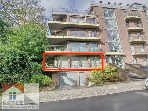 an apartment building with a red balcony on the side of it at Appartement 120m2 plus terrasse in Brussels