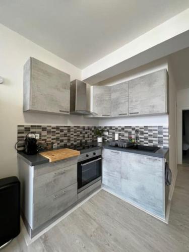 a kitchen with stainless steel appliances in a room at Eymet Holiday Rentals in Eymet