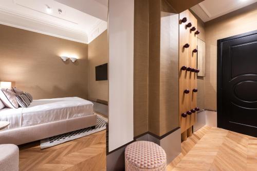 a hotel room with a bed and a chair at The Couper Umiltà in Rome