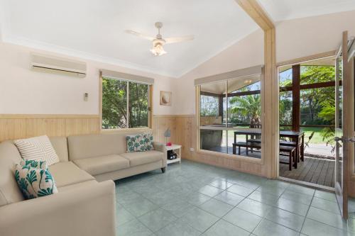 a living room with a couch and a table at Seven Mile Beach Holiday Park in Gerroa