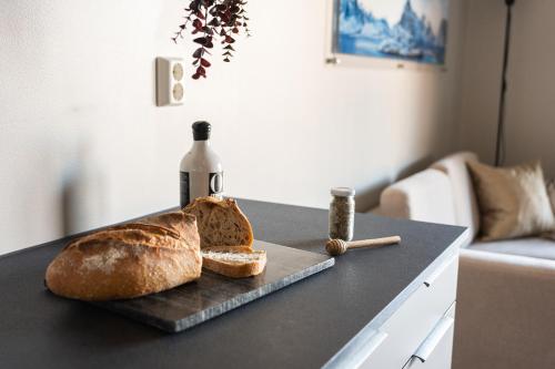 a table with bread and a bottle of wine at BJØRVIKA APARTMENTS, Opera Area, Oslo city center in Oslo