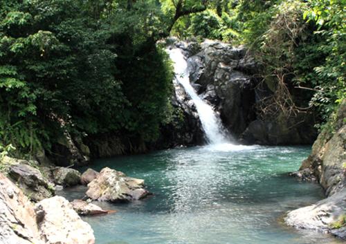 a waterfall in the middle of a river at Shanti Natural Panorama View Hotel in Singaraja
