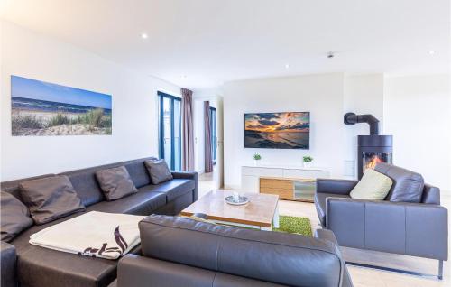 a living room with two couches and a fireplace at Penthouse Garden in Binz