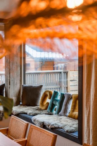 a reflection of a couch with pillows in a window at CHILL HOUSE in Schladming