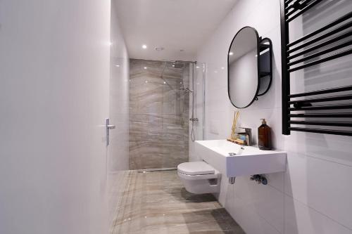 a bathroom with a toilet and a sink and a mirror at The Art Gallery - Mario's Place - By T&S in Eindhoven