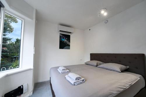a bedroom with a large bed with towels on it at Stratum Apartment No Kitchen Mario's - By T&S in Eindhoven