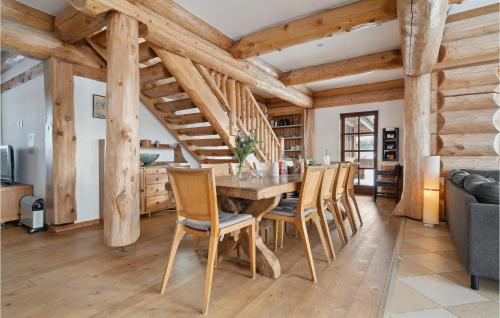 a dining room with a wooden table and chairs at Stunning Home In Nimtofte With Kitchen in Nimtofte