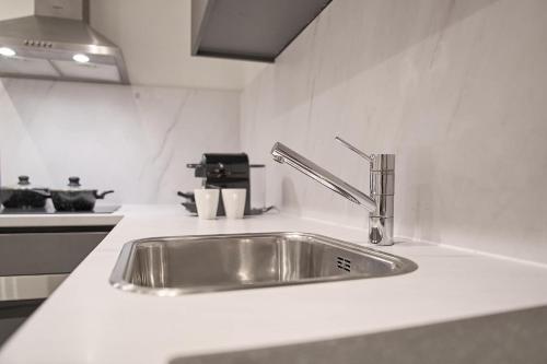 a kitchen counter with a stainless steel sink at Stratum's Theo's Loft - By T&S in Eindhoven