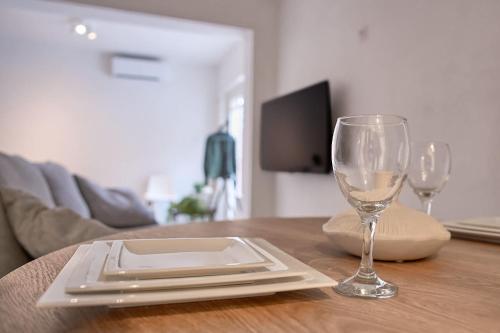a table with a plate and a wine glass on it at Stratum's Theo's Loft - By T&S in Eindhoven