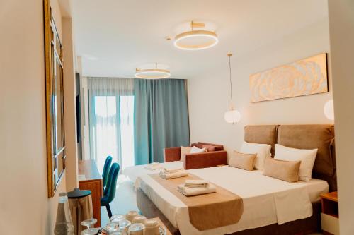 a hotel room with a bed and a table and chairs at Sky Boutique Hotel in Perea