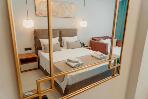 a reflection of a bedroom with a bed in a mirror at Sky Boutique Hotel in Perea