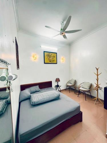 a bedroom with a bed and a ceiling fan at Bamboo Homestay Old Quarter in Hanoi