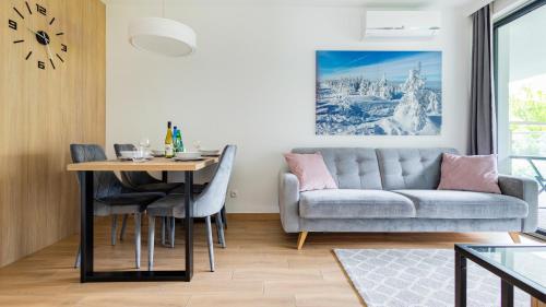 a living room with a couch and a table at Kalinowa z sauną, Sun & Snow in Szczyrk