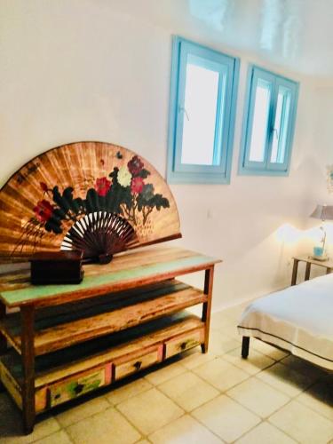 a bedroom with a bed and a wooden headboard at House by the sea in Kea Cyclades in Melissaki
