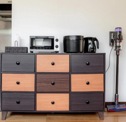a dresser with a microwave on top of it at KAKUREGA by unito in Hakodate