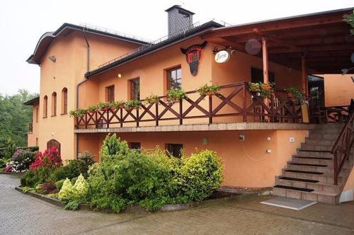 a building with a balcony with plants on it at Gostar in Jelenia Góra