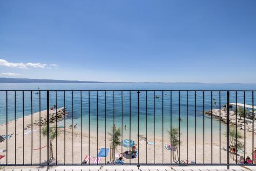 a view of the beach and ocean from a balcony at Hotel Aria in Podstrana